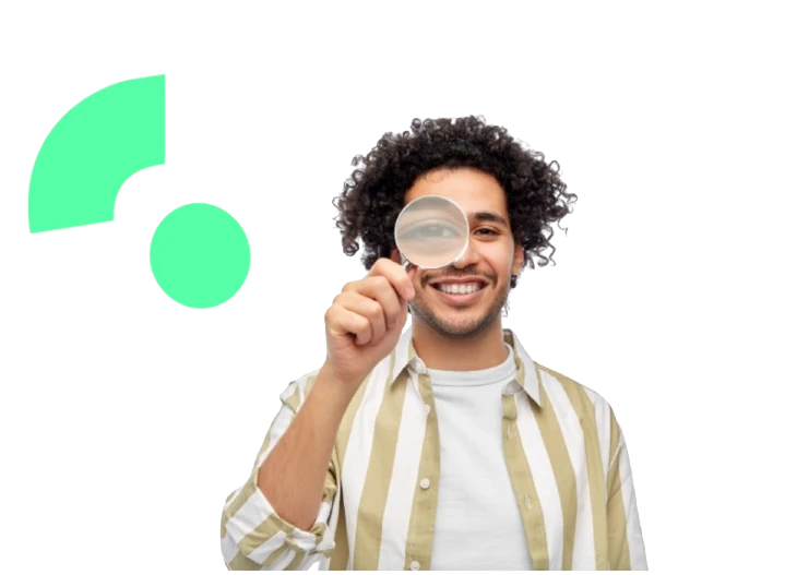 Smiling man looking through a magnifying glass